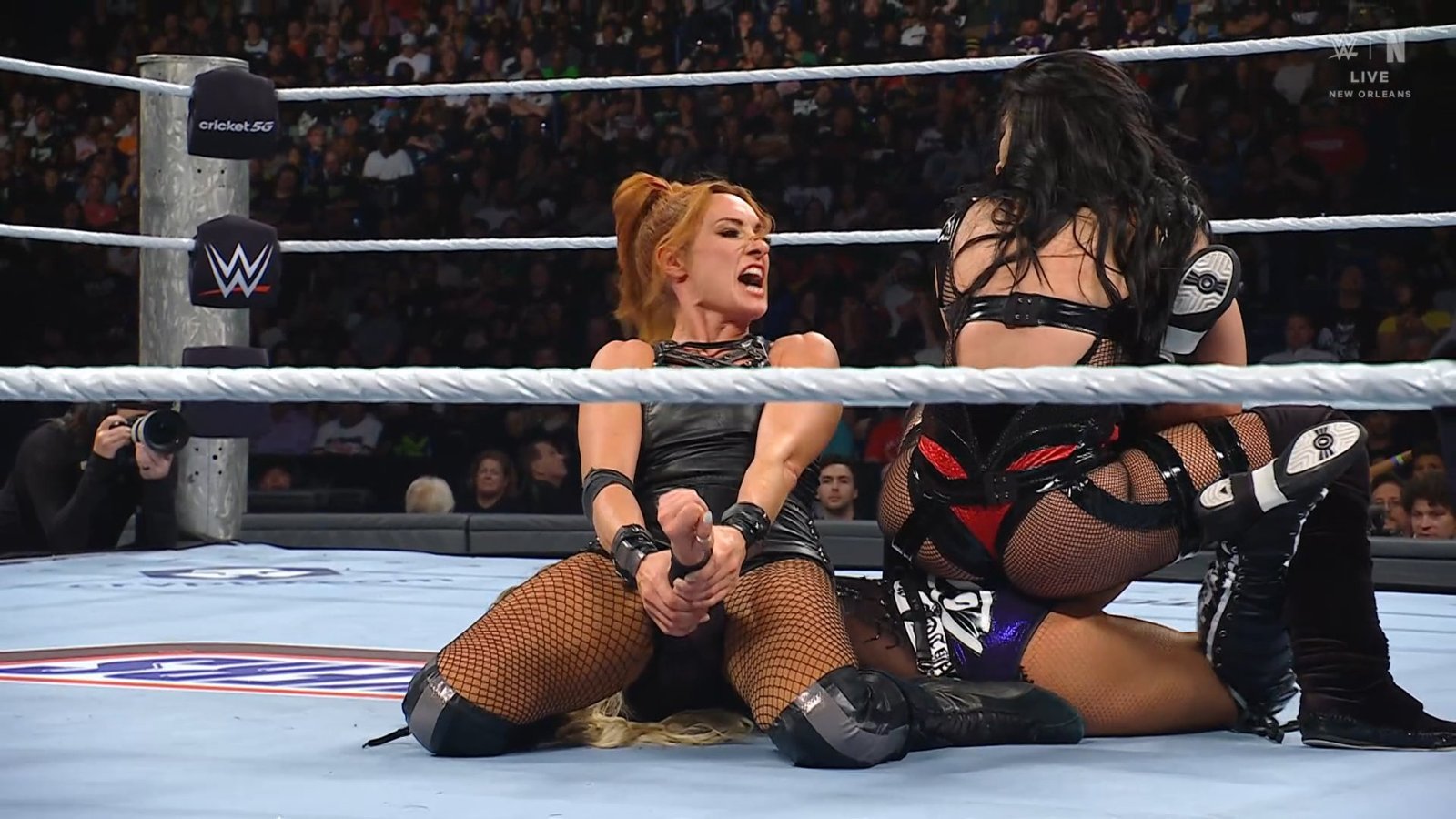 Becky Lynch aplica una llave mientras Stephanie Vaquer y Liv Morgan luchan en la triple amenaza por el Campeonato Mundial Femenil en WWE Money in the Bank 2026